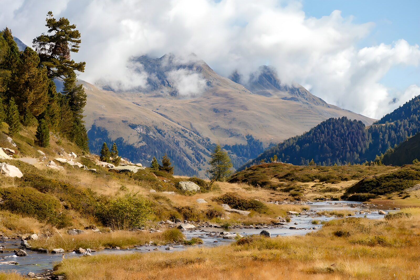 Berglandschaft mit Fluss und Wolken