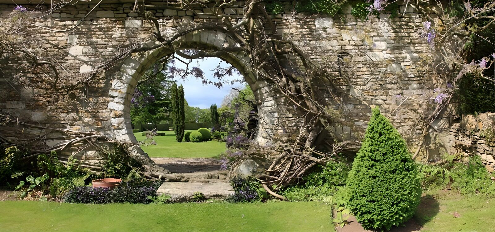 Gartenaugenblick durch einen Steinbogen